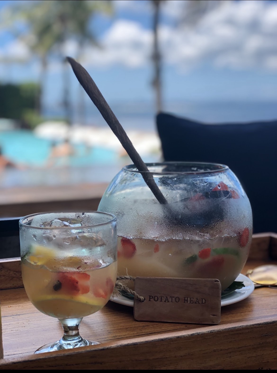 A cocktail at Potato Head, Bali, with the pool and beach in the background